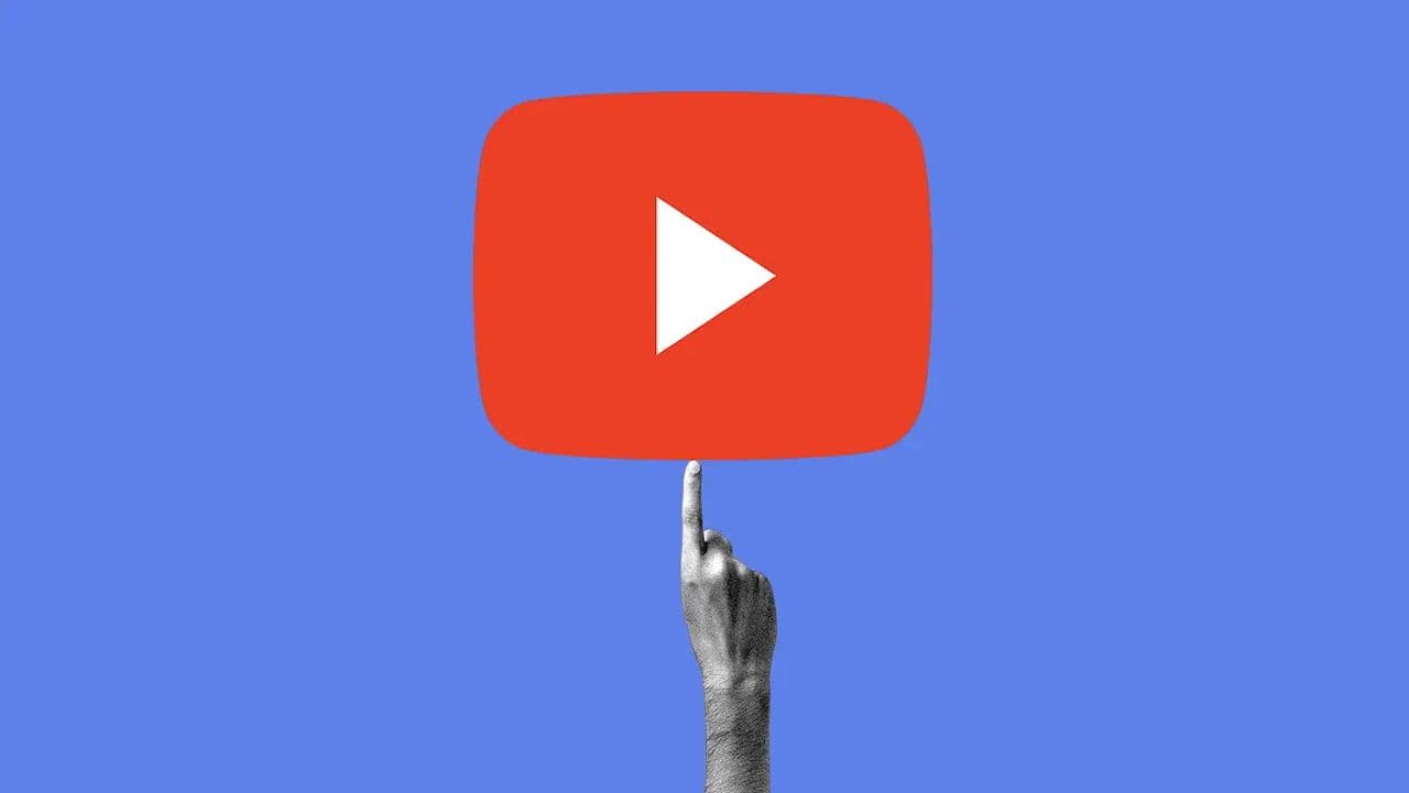 A hand spinning the YouTube logo